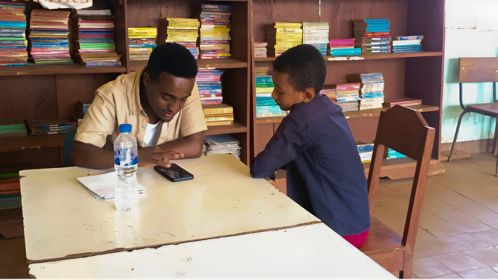 NALA field officer explains hygiene lesson to primary school student inside a classroom in South West Ethiopia Peoples Region.